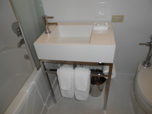 a white sink with a silver stand