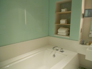 a bathtub and shelves in a bathroom