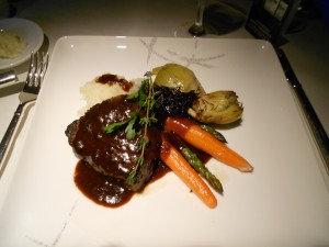 Grilled USDA prime beef tenderloin with creme de cassis onion marmalade, mashed potatoes, baby carrots, asparagus, and artichoke