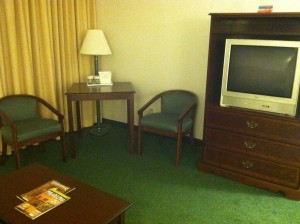 Adjacent to my bed was a sitting area featuring a loveseat, chairs, TV, etc.